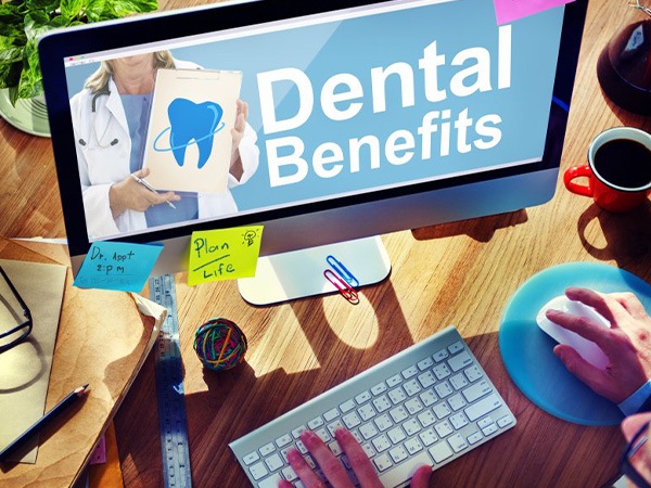 Person on computer with Dental Benefits on screen