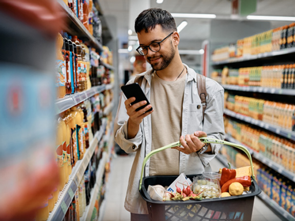 Man smiling while gorcery shopping