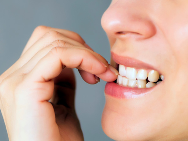 Closeup of patient biting their nails