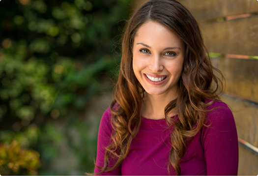 Smiling woman in a magenta blouse