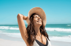 Woman stretching at the beach and smiling