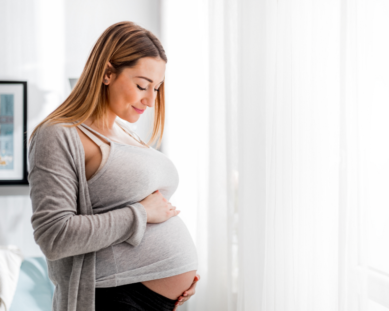Pregnant woman holding belly